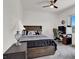 Spare bedroom is well-lit with a large bed, desk and large window at 8870 Sasquatch Run Ave, Las Vegas, NV 89166