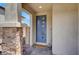 Inviting entryway with a stylish blue front door, stone accents, and 'Welcome' mat at 8870 Sasquatch Run Ave, Las Vegas, NV 89166