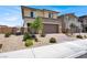 Two-story home featuring a brick driveway, landscaped front yard, and neutral color scheme at 8870 Sasquatch Run Ave, Las Vegas, NV 89166