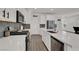 Modern kitchen features stainless steel appliances, a spacious island, and stylish gray backsplash at 8870 Sasquatch Run Ave, Las Vegas, NV 89166