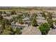 Aerial view of tan roofs on townhomes, with palm trees, green trees, a community pool, and a desert scene at 915 Graceful Moon Ave, Henderson, NV 89015