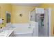 Bathroom features a soaking tub with tile surround and glass enclosed shower at 915 Graceful Moon Ave, Henderson, NV 89015