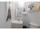 Small bathroom features a modern sink and vanity, decorative wall art, and a toilet at 915 Graceful Moon Ave, Henderson, NV 89015