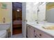 Well-lit bathroom with white cabinets and a coordinated color scheme, as seen from the bedroom doorway at 915 Graceful Moon Ave, Henderson, NV 89015