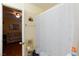 Bathroom features a shower with patterned curtain, and a view into the bedroom at 915 Graceful Moon Ave, Henderson, NV 89015