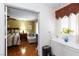 View of a bedroom from the doorway showcases warm colors, hardwood floors, and a decorated window at 915 Graceful Moon Ave, Henderson, NV 89015
