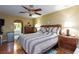 Spacious bedroom features a ceiling fan, wood floors, and a bed with decorative pillows at 915 Graceful Moon Ave, Henderson, NV 89015