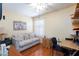 Comfortable bedroom features hardwood floors, a ceiling fan, and a cozy sitting area at 915 Graceful Moon Ave, Henderson, NV 89015