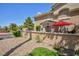 View of the front exterior features a red umbrella, complemented by attractive landscaping at 915 Graceful Moon Ave, Henderson, NV 89015