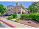 Beautiful townhome exterior with mature trees and manicured shrubbery at 915 Graceful Moon Ave, Henderson, NV 89015