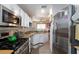 Well-equipped kitchen with stainless steel appliances, light countertops, and light-colored cabinets at 915 Graceful Moon Ave, Henderson, NV 89015