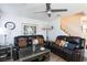 Comfortable living room with fireplace and contemporary ceiling fan at 915 Graceful Moon Ave, Henderson, NV 89015