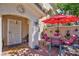 Charming outdoor patio with a dining set under a bright red umbrella, creating a cozy retreat at 915 Graceful Moon Ave, Henderson, NV 89015