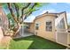 A tranquil backyard features a green lawn area and a covered patio, perfect for relaxation at 925 Crescent Falls St, Henderson, NV 89011