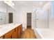 Bathroom featuring double sinks, wood floors, and a glass-enclosed shower at 925 Crescent Falls St, Henderson, NV 89011