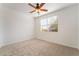 This bedroom has a ceiling fan, neutral carpet and natural light at 925 Crescent Falls St, Henderson, NV 89011