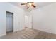 Carpeted bedroom with standard closet and ceiling fan at 925 Crescent Falls St, Henderson, NV 89011