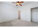 Carpeted bedroom featuring a ceiling fan and a sliding door closet at 925 Crescent Falls St, Henderson, NV 89011