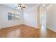 Bright bedroom with wood-look tile floors, ceiling fan and bright window at 925 Crescent Falls St, Henderson, NV 89011