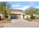 Charming single-story home featuring a desert landscape, a two-car garage, and a concrete driveway at 925 Crescent Falls St, Henderson, NV 89011