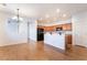 Inviting kitchen with wood cabinets, granite countertops, and an island with bar seating at 925 Crescent Falls St, Henderson, NV 89011