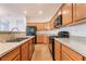 Modern kitchen features wooden cabinets, granite countertops, and black appliances at 925 Crescent Falls St, Henderson, NV 89011