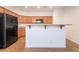 Kitchen with wood cabinets, granite countertops and a black refrigerator at 925 Crescent Falls St, Henderson, NV 89011