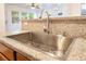 Close up of the kitchen sink, faucet and granite countertop at 925 Crescent Falls St, Henderson, NV 89011