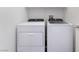 Well-lit laundry area with modern side-by-side washer and dryer units at 925 Crescent Falls St, Henderson, NV 89011