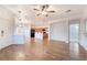 Bright living area open to the kitchen, featuring wood-look tile and a ceiling fan at 925 Crescent Falls St, Henderson, NV 89011