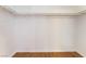Clean, white walk-in closet with wood-look flooring and ample shelving at 925 Crescent Falls St, Henderson, NV 89011