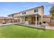 Backyard featuring well maintained artificial turf, covered patio, and outdoor seating at 9630 Tuscola Ct, Las Vegas, NV 89148