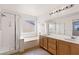 Modern bathroom featuring dual sinks, a glass-enclosed shower, and a soaking tub at 9630 Tuscola Ct, Las Vegas, NV 89148