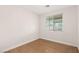 Bright bedroom with wood laminate flooring and a large window with natural light at 9630 Tuscola Ct, Las Vegas, NV 89148