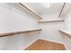 Walk-in closet provides ample shelving, and wooden rails for organization at 9630 Tuscola Ct, Las Vegas, NV 89148