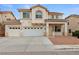 Charming two-story home featuring a three-car garage, landscaped front yard, and a classic desert color palette at 9630 Tuscola Ct, Las Vegas, NV 89148