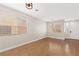 Bright living room featuring wood floors, large windows, and a welcoming entry way at 9630 Tuscola Ct, Las Vegas, NV 89148