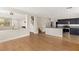 Open living space with wood floors, staircase access, and a modern kitchen with stainless appliances at 9630 Tuscola Ct, Las Vegas, NV 89148
