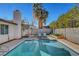 Refreshing pool surrounded by desert landscaping and comfortable lounge area at 976 El Camino Way, Boulder City, NV 89005