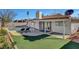 This backyard features a sparkling pool, artificial turf, and a covered patio, perfect for outdoor relaxation and entertaining at 976 El Camino Way, Boulder City, NV 89005