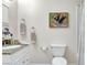 Well-maintained bathroom with a granite vanity top, white cabinetry, and a decorative painting at 976 El Camino Way, Boulder City, NV 89005