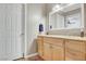 Bathroom with a wooden vanity, large mirror, and tile floors at 976 El Camino Way, Boulder City, NV 89005
