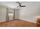 Bright bedroom with hardwood floors, a ceiling fan, and a large window, offering ample natural light at 976 El Camino Way, Boulder City, NV 89005