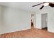 Bright, open bedroom featuring hardwood floors, a ceiling fan, and convenient closet access at 976 El Camino Way, Boulder City, NV 89005