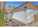 A charming home exterior features a light-blue door and desert landscaping with cacti and a stone walkway at 976 El Camino Way, Boulder City, NV 89005