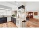 Open kitchen featuring modern appliances, white cabinets, and a dining area nearby at 976 El Camino Way, Boulder City, NV 89005
