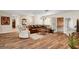 Bright living room with hardwood flooring, a cozy sectional, and French doors leading to outdoor space at 976 El Camino Way, Boulder City, NV 89005