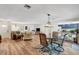 Open-concept living room featuring hardwood floors, dining area, and modern lighting, ideal for Gathering gatherings at 976 El Camino Way, Boulder City, NV 89005