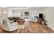 Inviting living room with a large sectional couch, wood flooring, and bright natural light at 976 El Camino Way, Boulder City, NV 89005