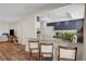 Open-concept space with kitchen island and bar seating at 976 El Camino Way, Boulder City, NV 89005